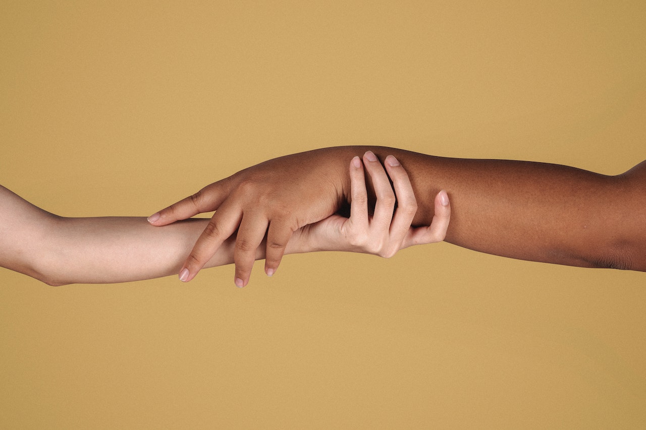 Diverse women showing respect to each other while holding hands