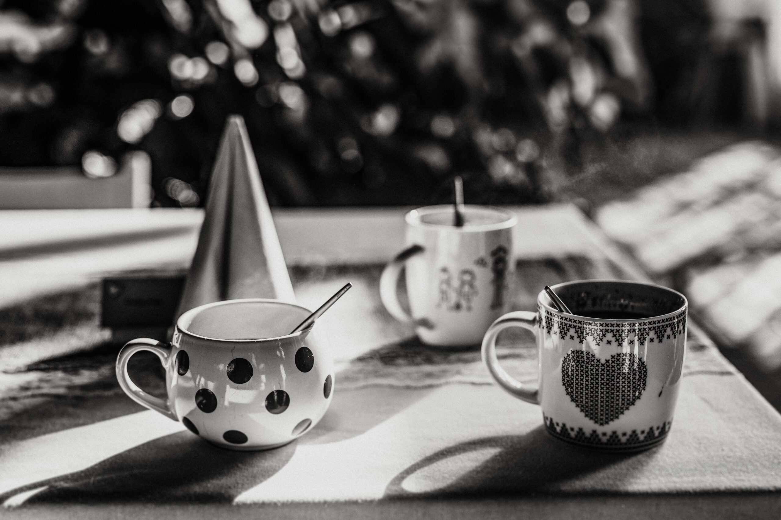 Mugs with heart and polka-dot designs on a table